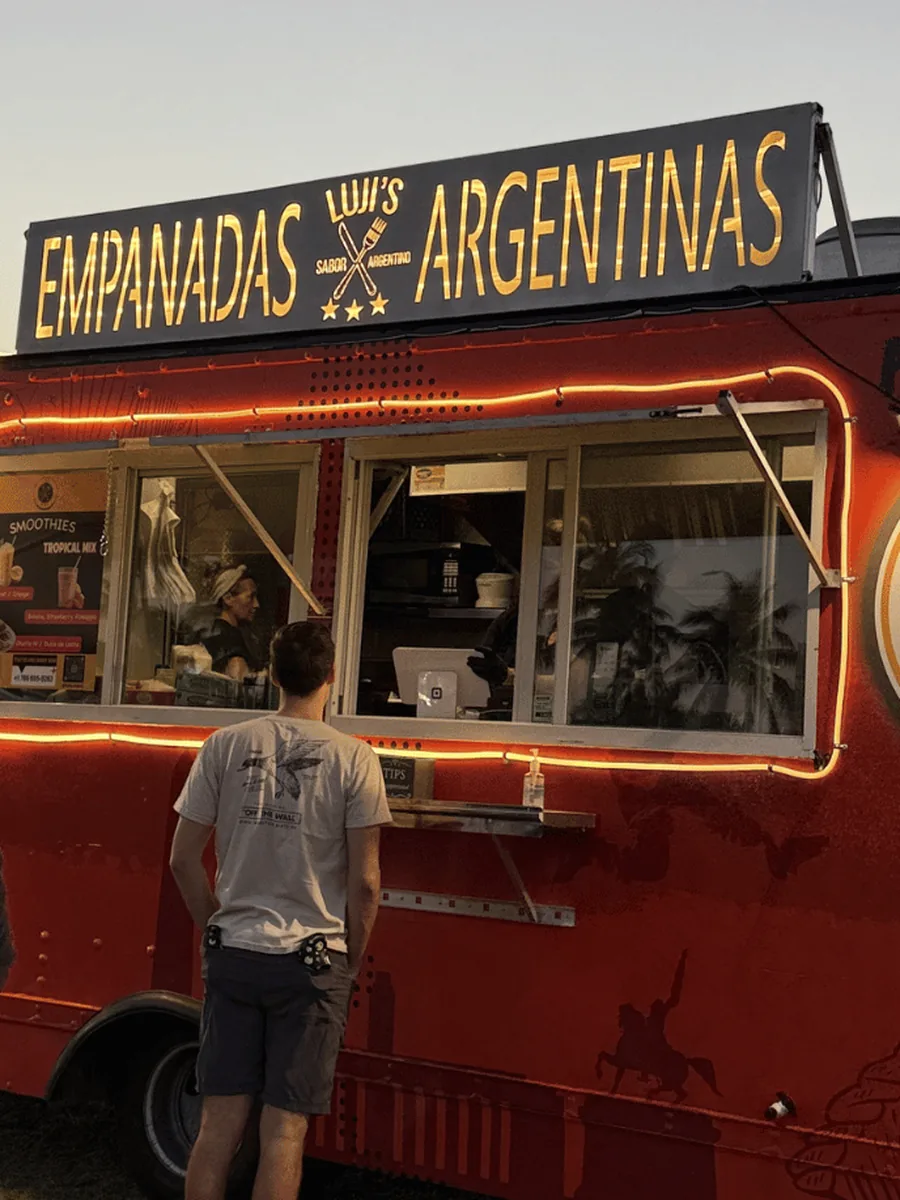 Luji's truck lit up at sunset with customers in line